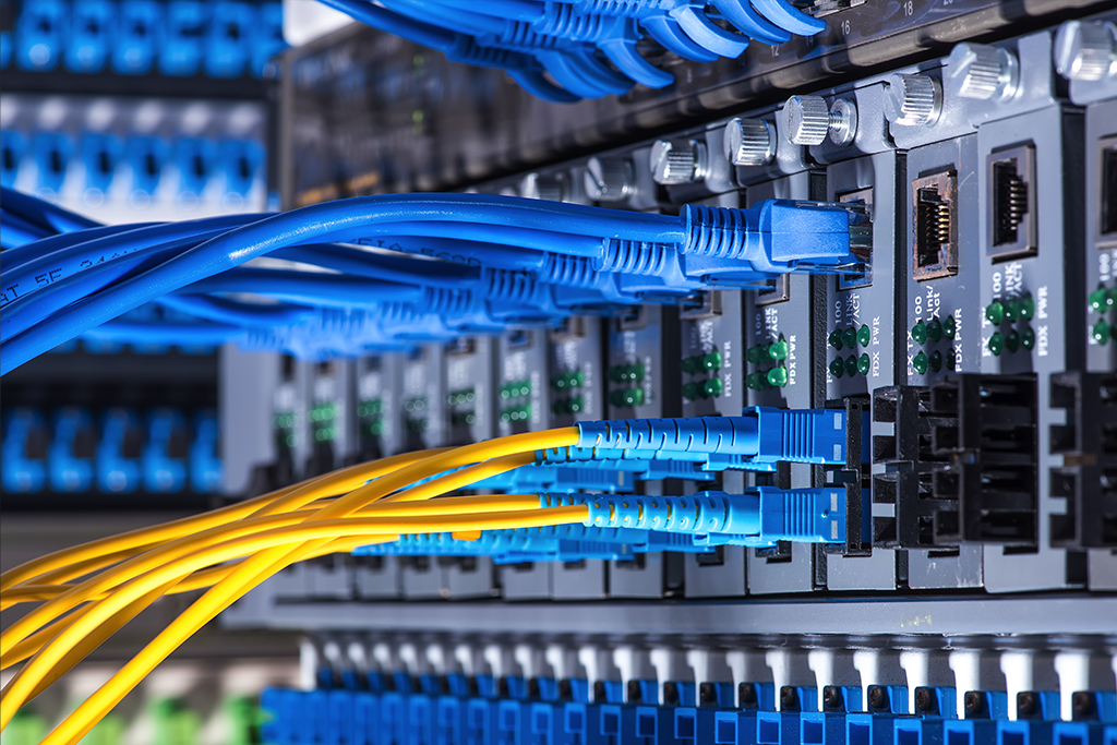 Fiber Optic cables and UTP Network cables connected hub ports.