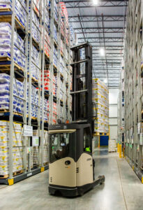 Forklift driver operating in warehouse